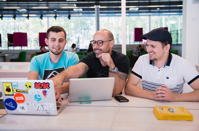 Tre studenter vid en dator